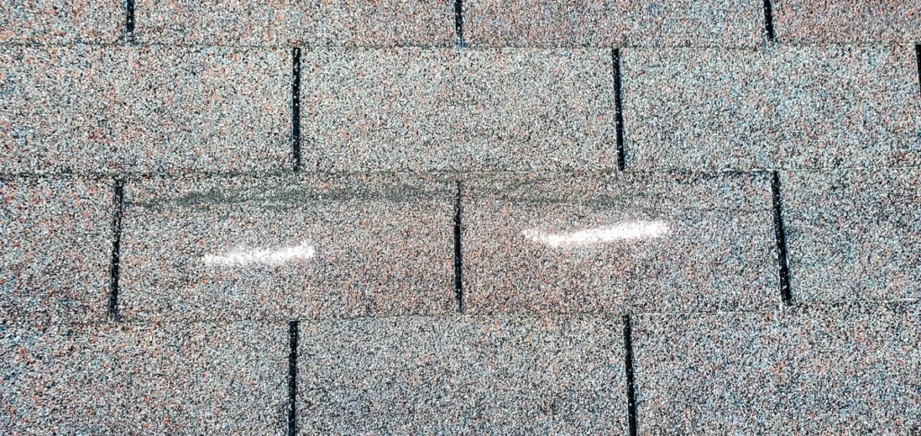 impact damage marked by insurance inspector after storm