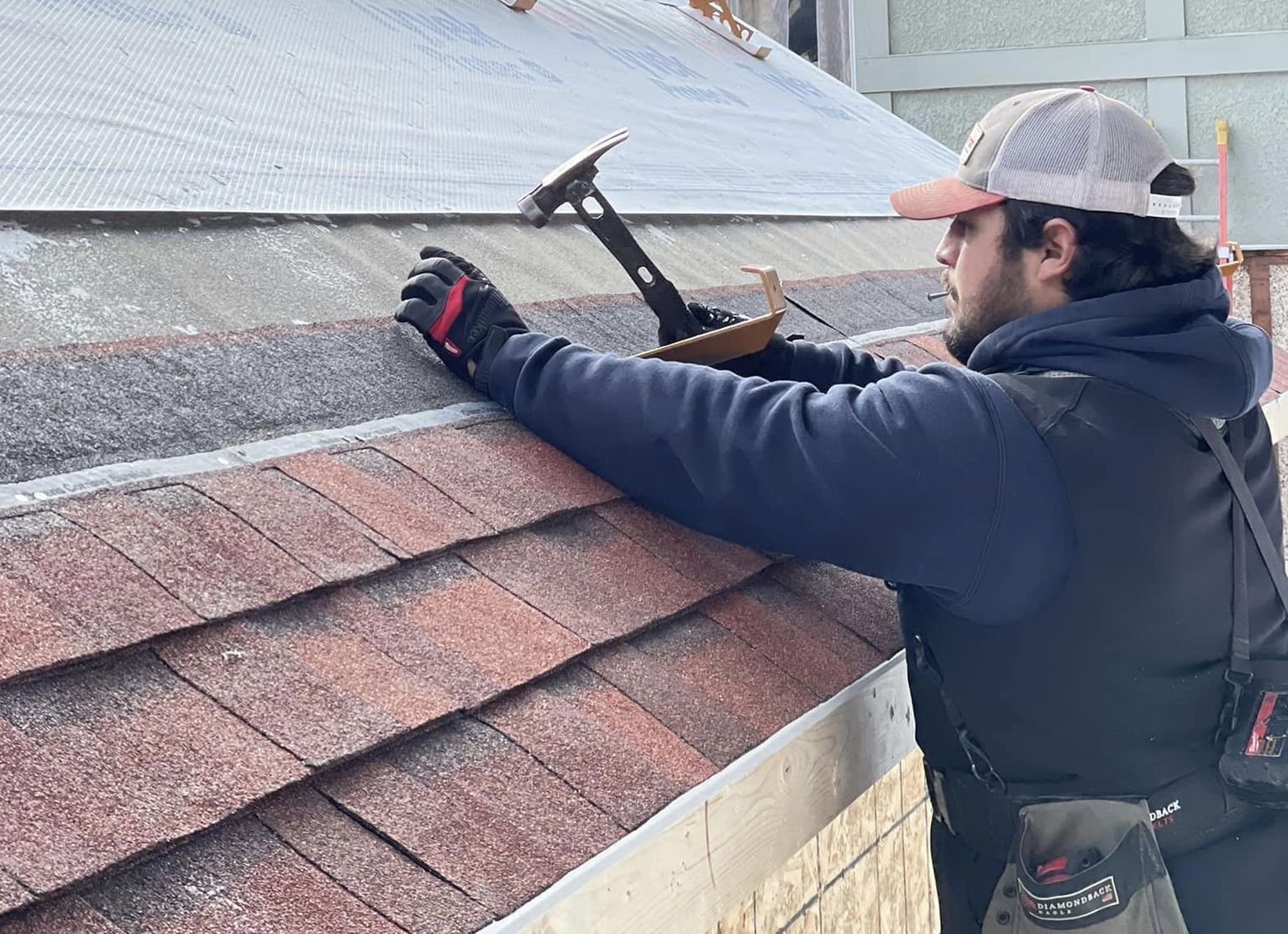 roofer installing shingles