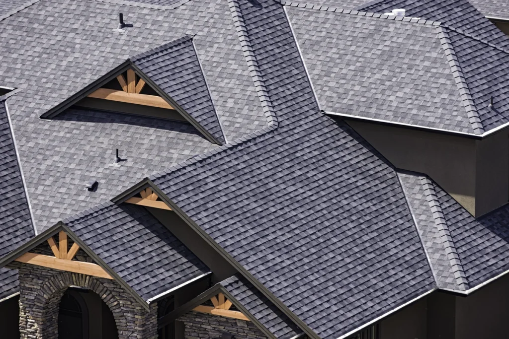 shingle roof cost-arial view of a home with dark shingles