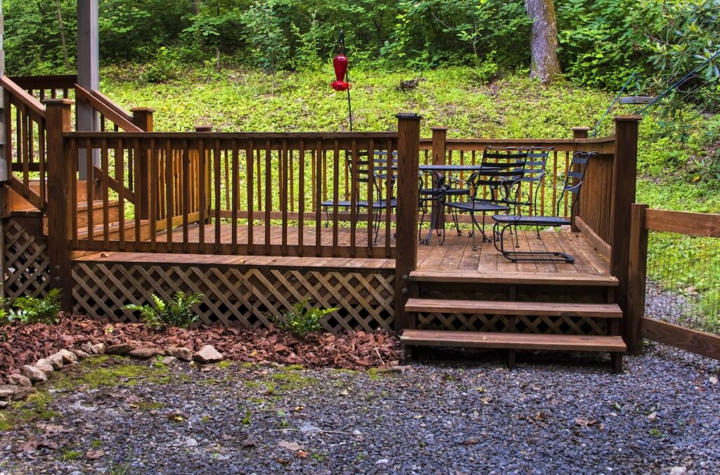 Wooden patio deck with furniture at cabin in North Carolina
