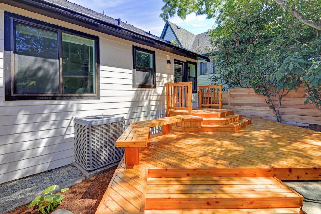 Walkout deck with stairs and backyard porch of a freshly renovated house