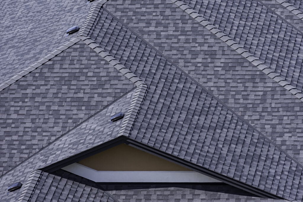 Rooftop in a newly constructed subdivision in shingles and multiple roof lines architectural shingles vs 3 tab