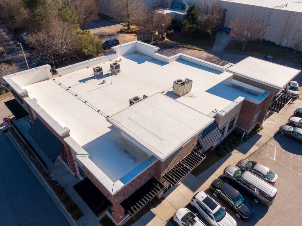 Sunny Day Time Drone Images of a TPO Roof on a Commercial Building. Rochester