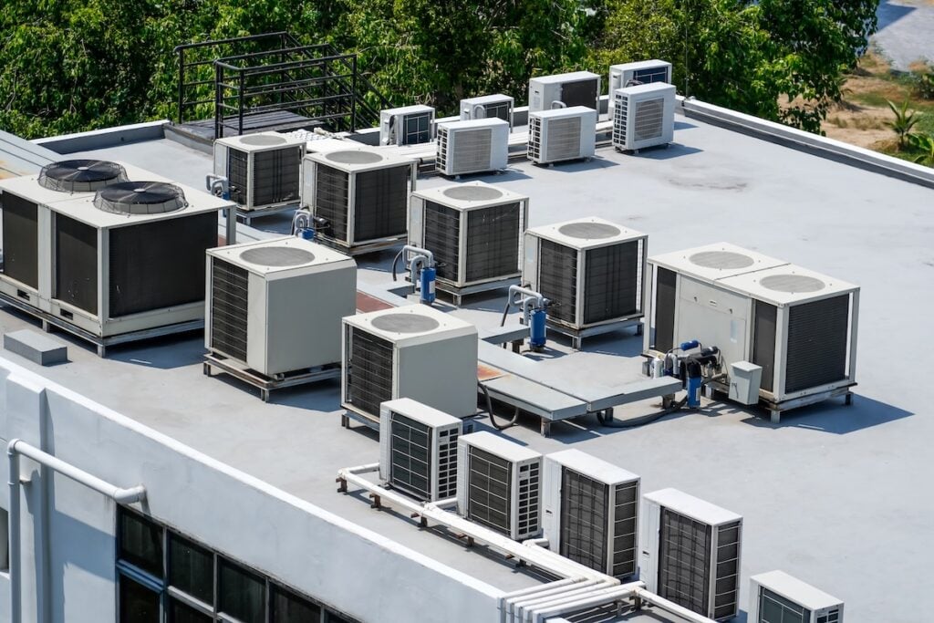 The external units of the commercial air conditioning and ventilation systems are installed on the roof of an industrial building