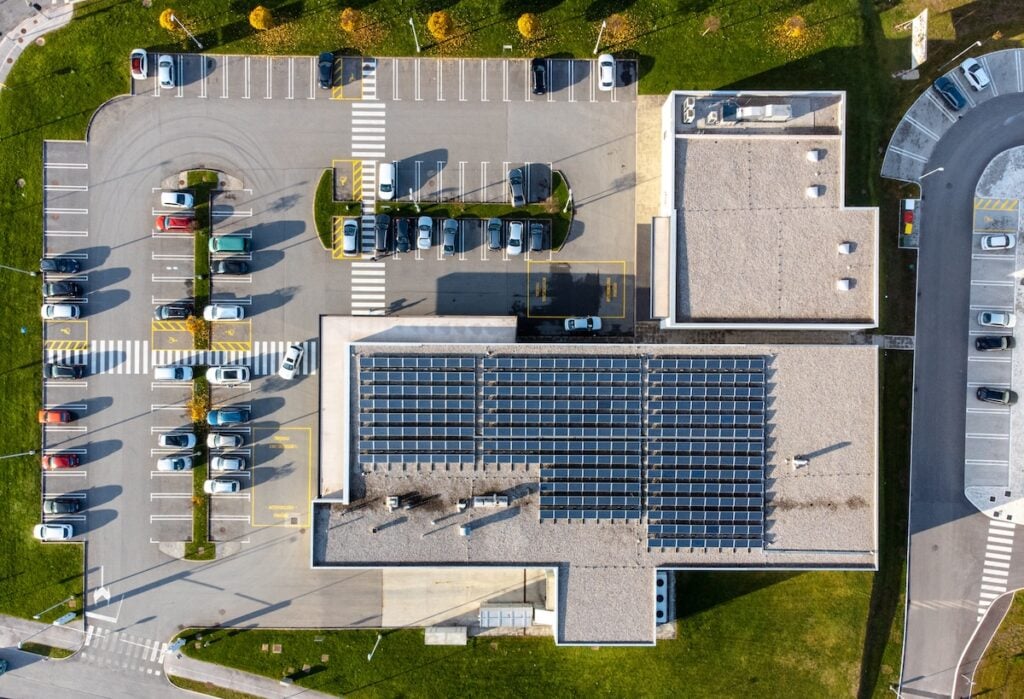 commercial flat roofing Array of solar panels on the roof of a commercial building top down