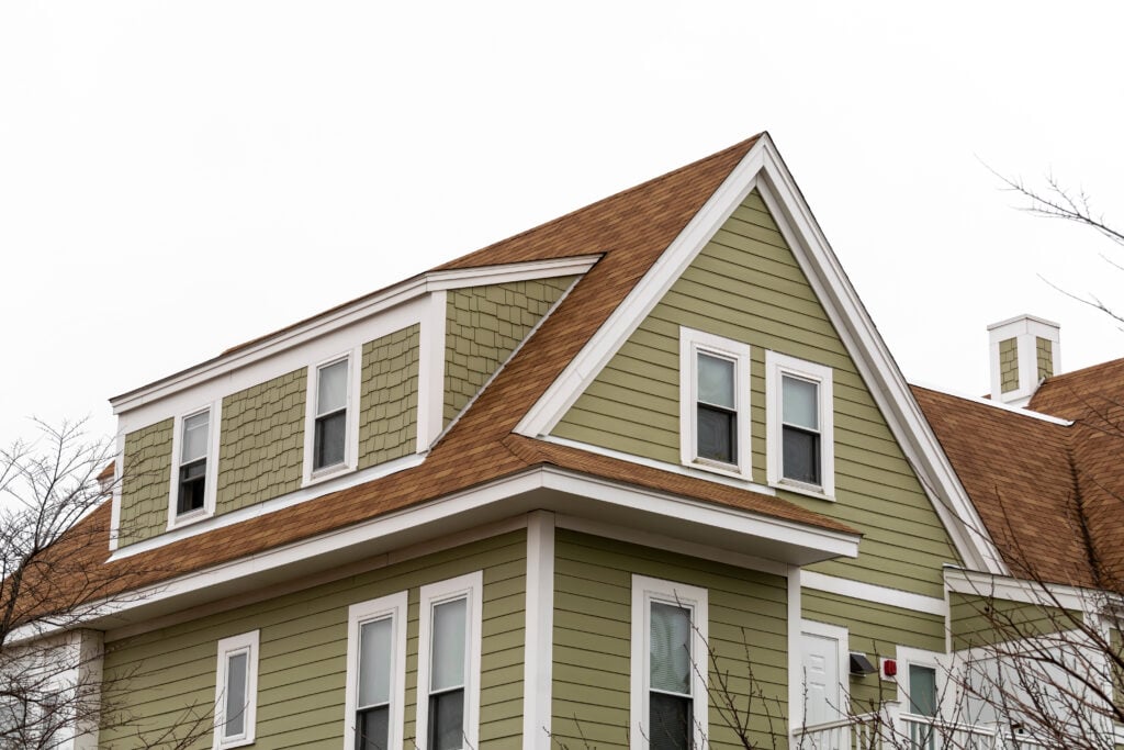 house siding colors Exterior view of a newly built family house with shed dormer windows on a winter day