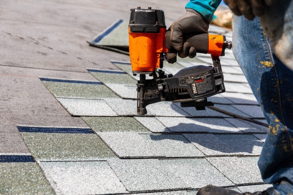 what are starter shingles roofer installing roof shingles with pnuematic roofing nailer.