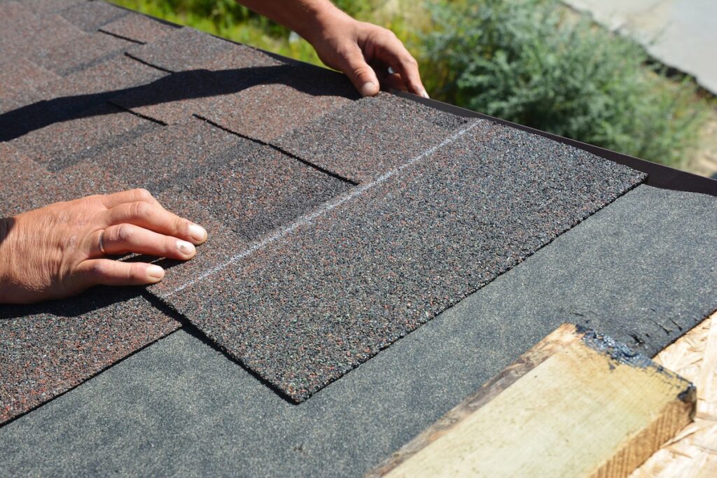 what are starter shingles Asphalt Shingles Installation. Roofer Contractor Installing Asphalt Shingles on House Roofing Construction at Faribault MN