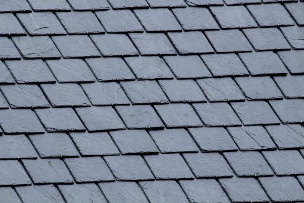 slate roof cost New slate roof, slate texture, perfect shape. Slating roof. Grey colors.