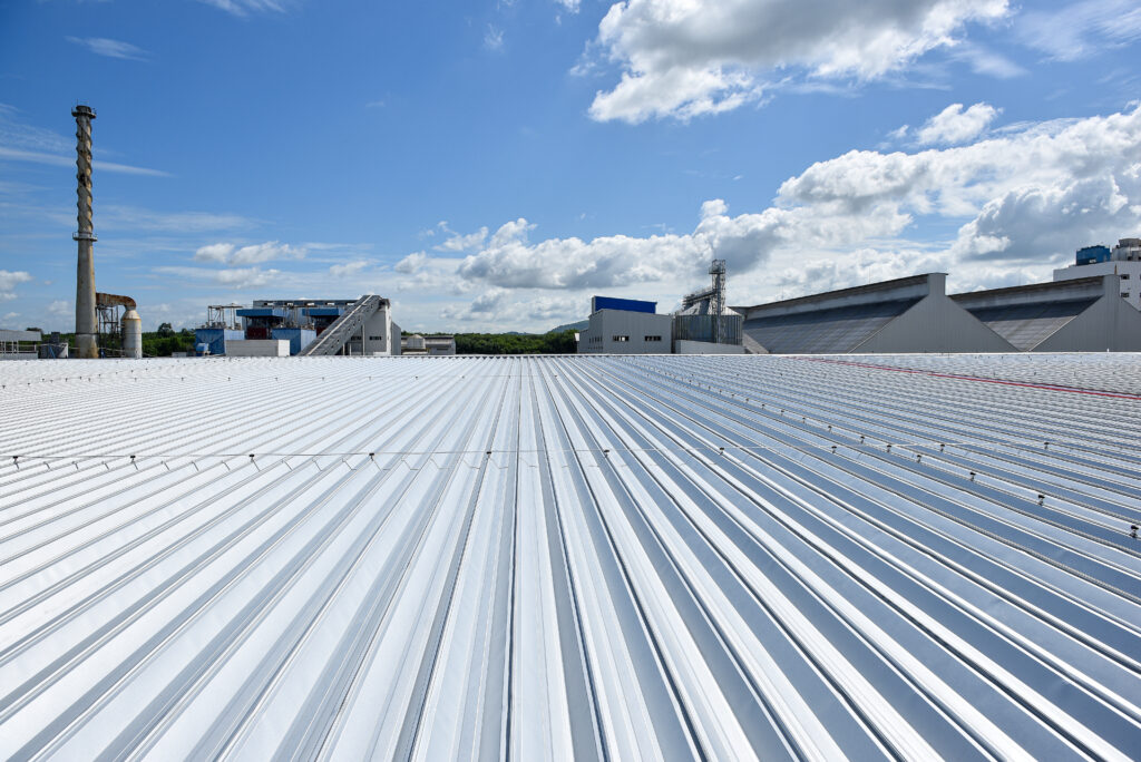 commercial metal roof Roofing and lightning faraday systemon installed on new warehouse with exsiting old building warehouse and blue sky background
