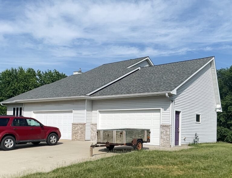 White house with a grey shingle roof