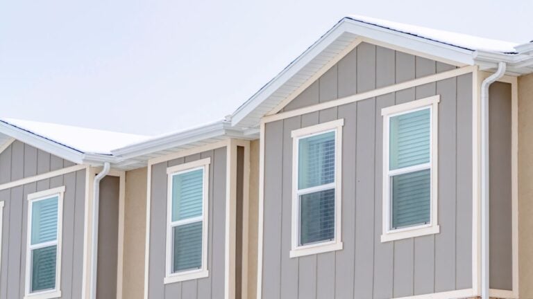 grey vertical siding square white panels windows