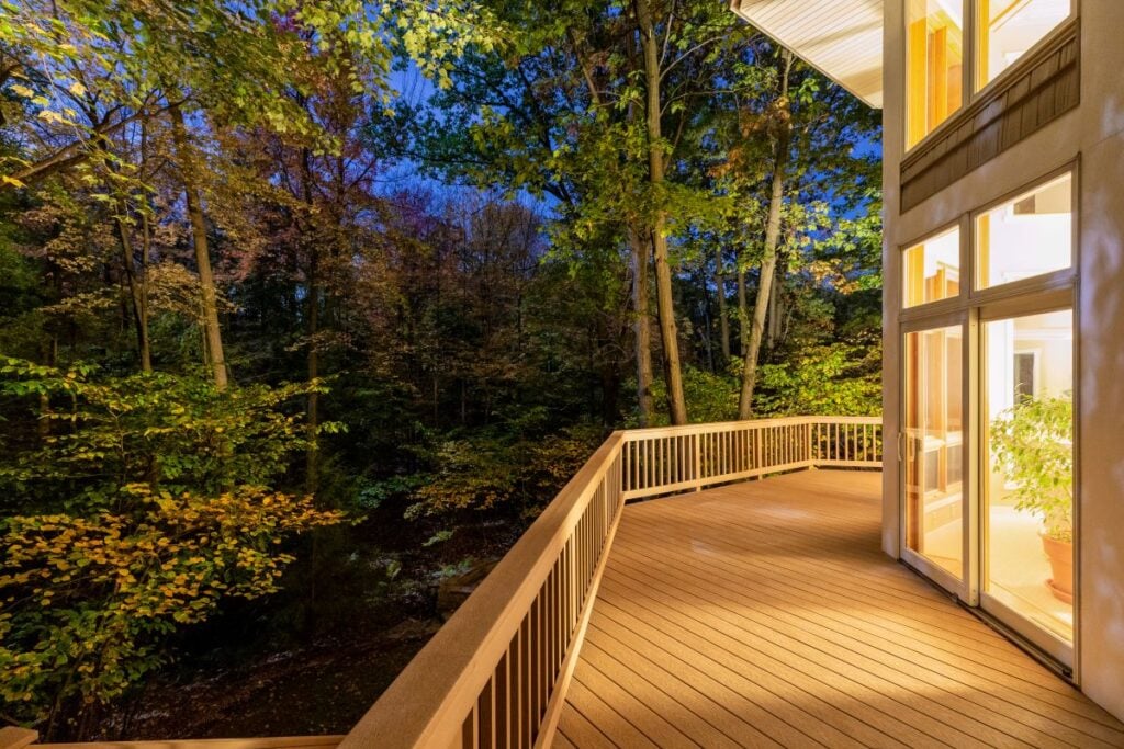 trex decking colors light wood deck around woods big house during night warm light