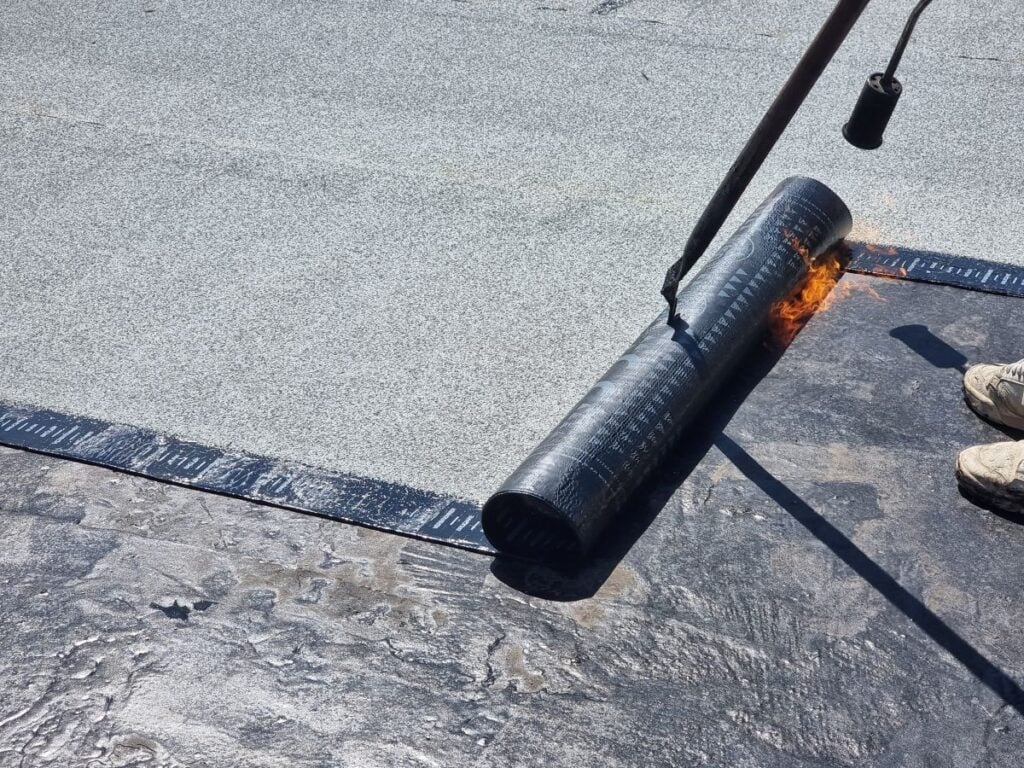 applying waterproofing to a flat roof