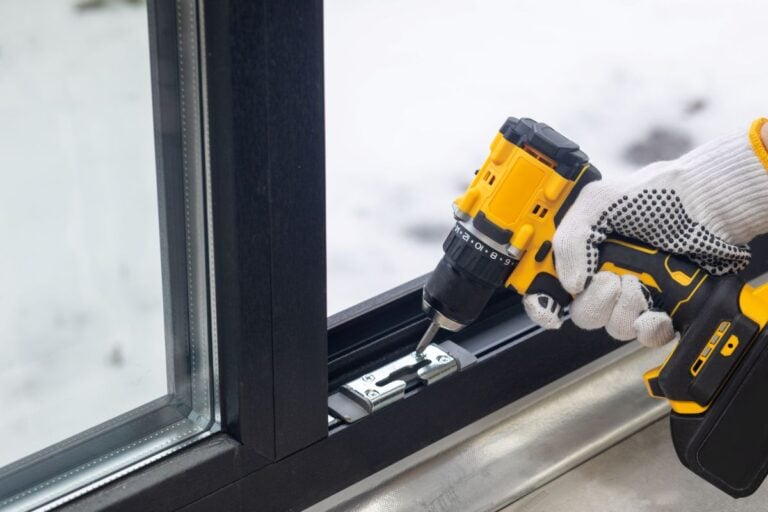 window installation worker using gloves adjusting fittings