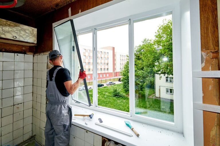window replacement cost worker installing new glass