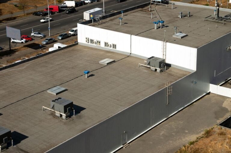 View of the roof of a commercial building in the middle of the city