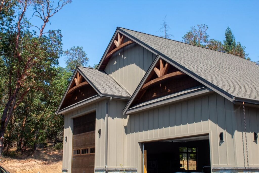 Large garage bays with arches and board and batten siding