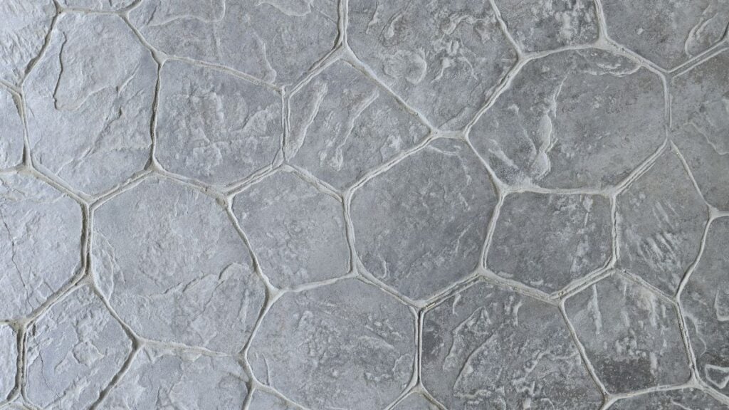 Natural grey stamped concrete or stone texture with a random flagstone pattern