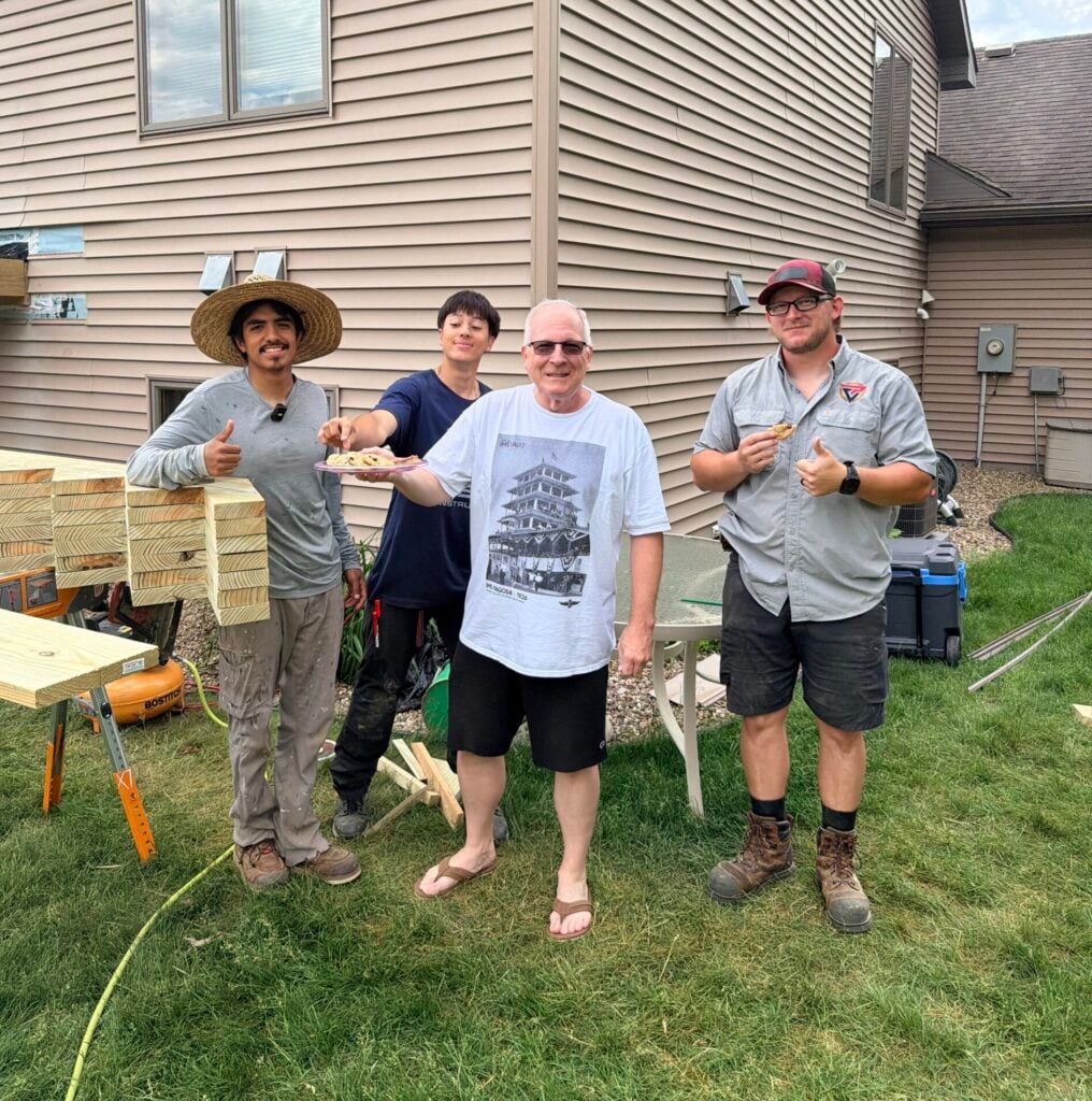 Production crew posing with client on a deck job in Rochester, Minnesota