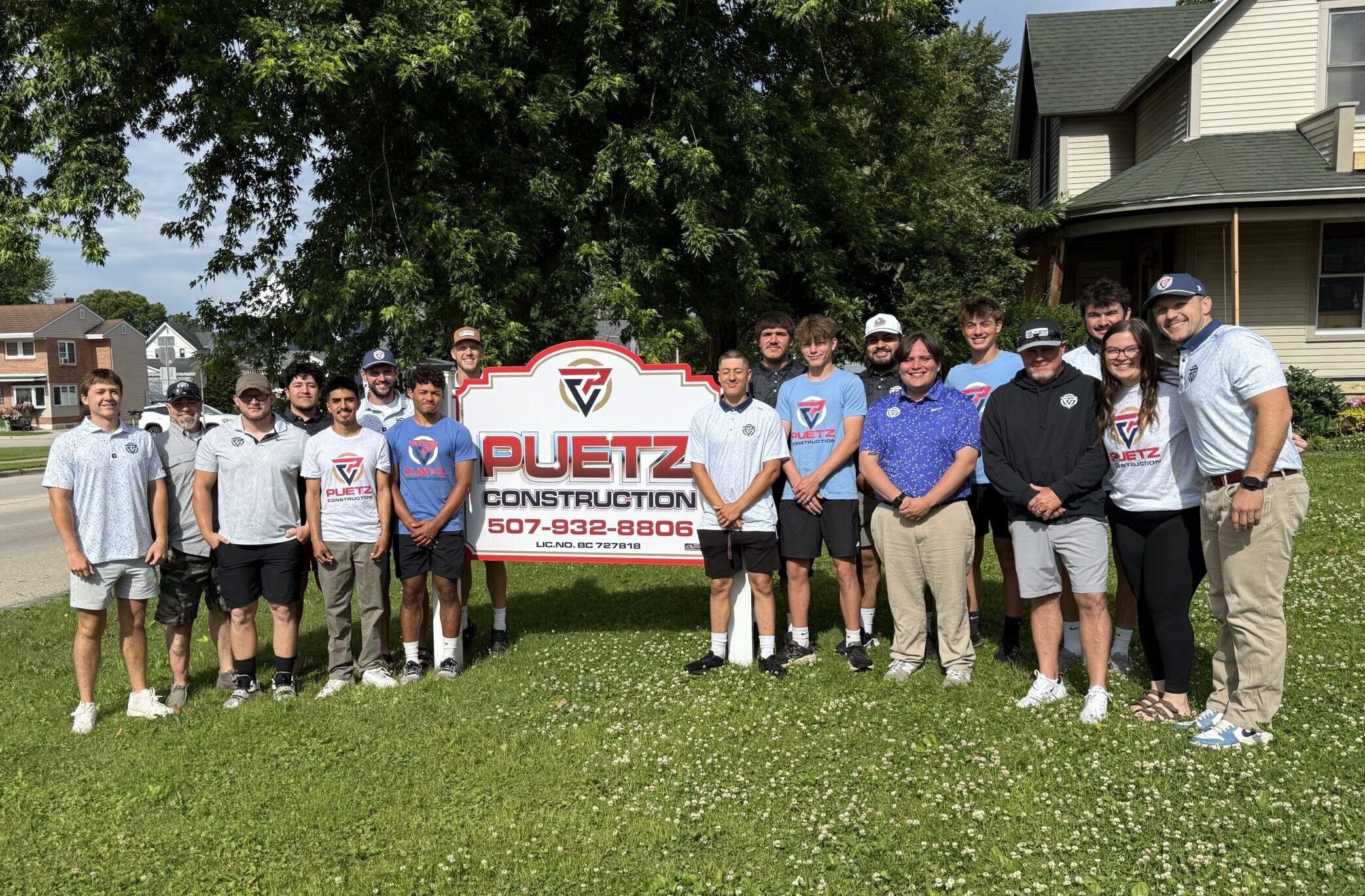 Puetz team in front of the sign in St. Charles, Minnesota