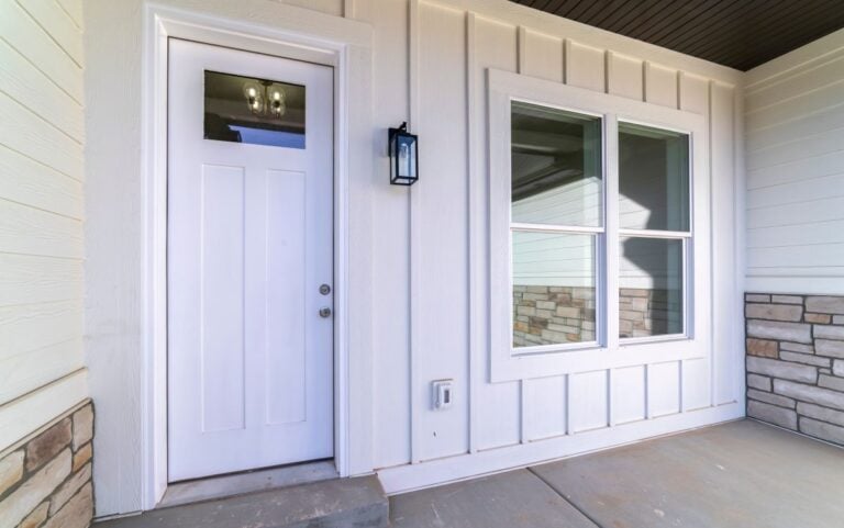 Large square window alongside a white fiberglass door