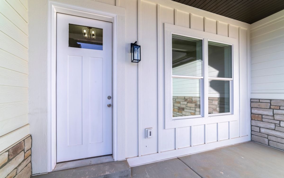 Large square window alongside a white fiberglass door