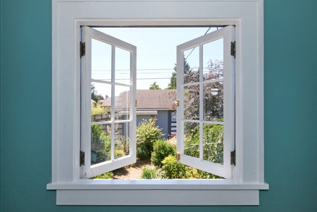 Open casement window to the back yard with small shed.