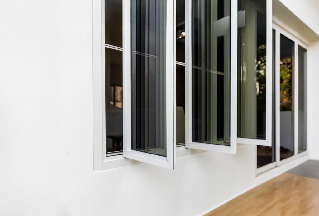 Three panel aluminium casement window on a white wall