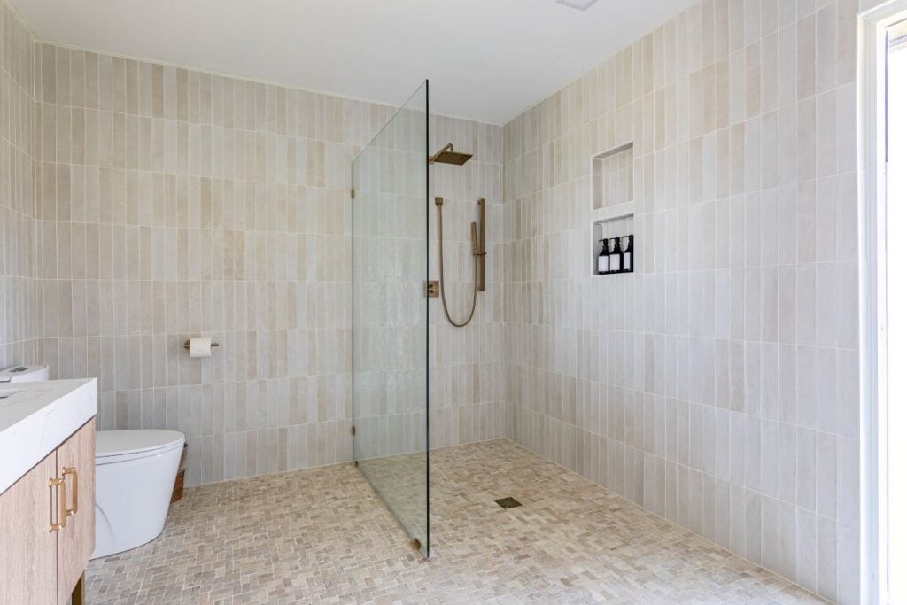 Modern walk-in shower bathroom with glass partition and neutral tile interior. Spa Bathroom Ideas to Create a Wellness Retreat at Home