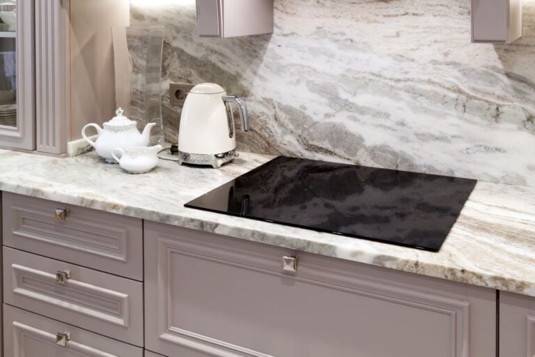 beautiful closeup of custom designed kitchen, with marble looking quartz countertop and backsplash