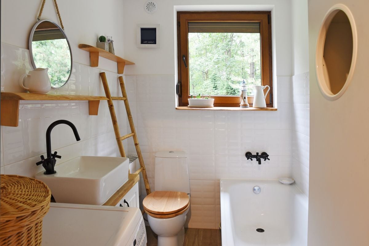 interior of small modern bathroom in white color and wooden decor
