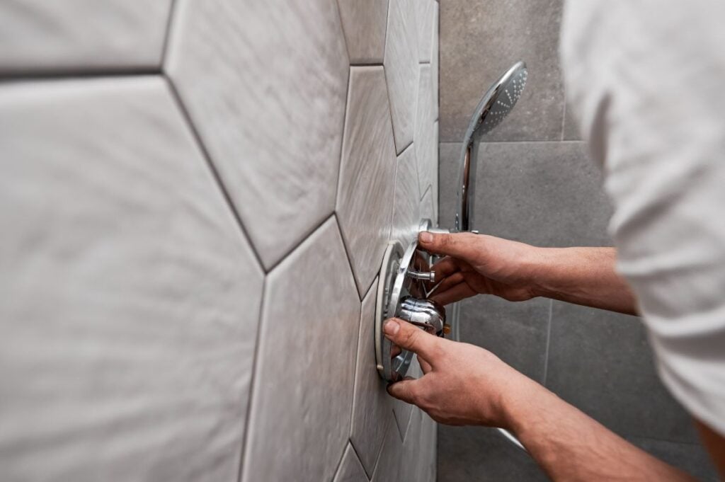 plumber working on bathroom renovation at home