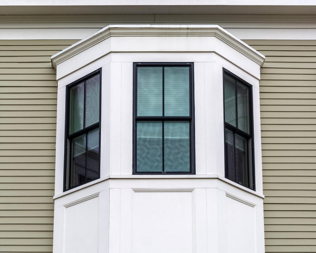 Architectural detail of a black-framed bay window