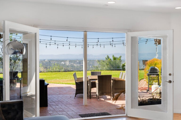 Living room with open patio door and large glass doors