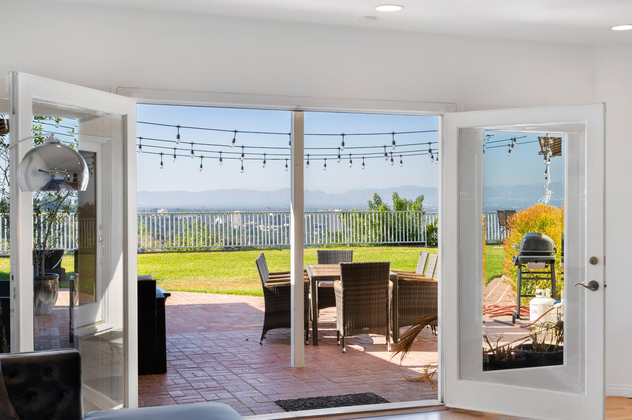 Living room with open patio door and large glass doors